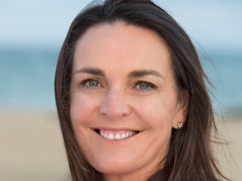 Dark-haired woman smiling.