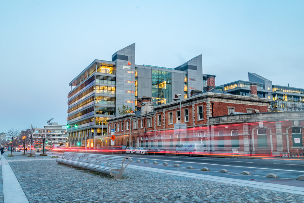 lights streak past PwC building on Dublin docks.