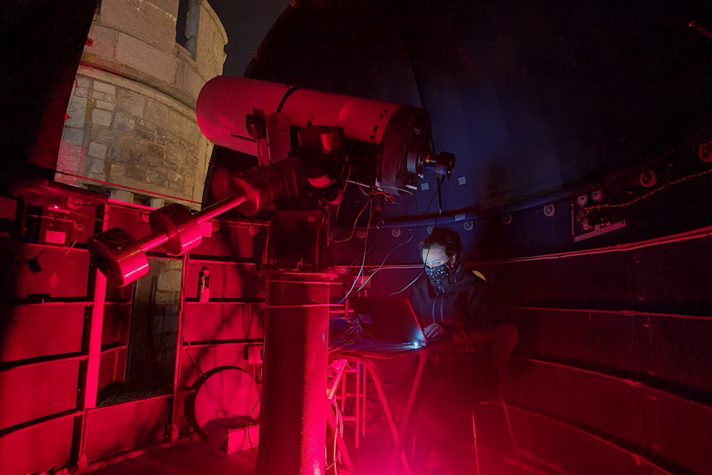 scientist working with telescope.