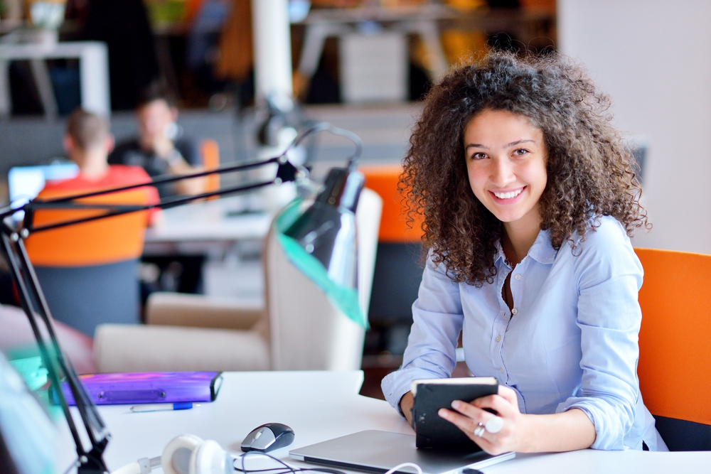 smiling woman at desk.