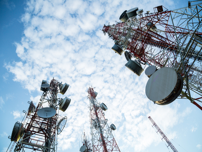 mobile antennae under a cloudy sky.