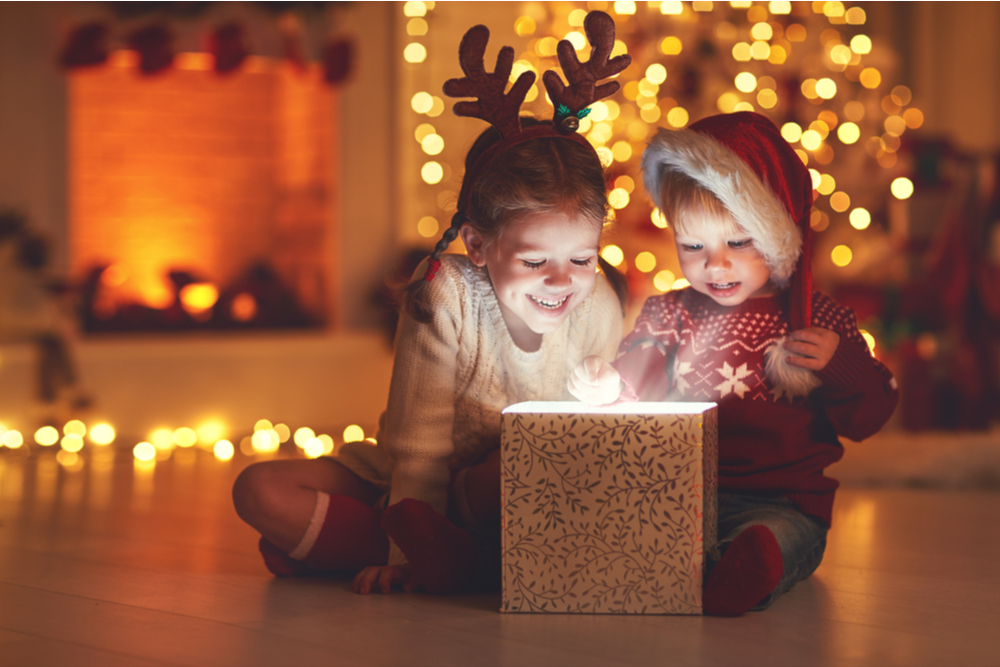 Children opening a gift at Christmas.