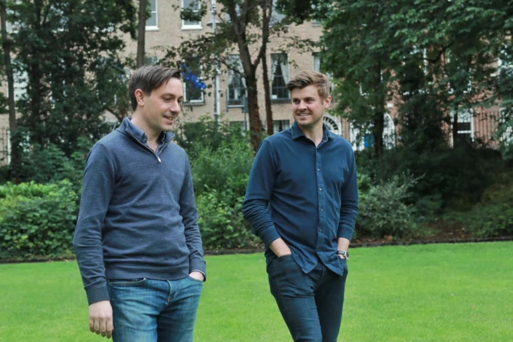 Two young men walking in a park in Dublin.