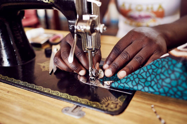 Hands at sewing machine.