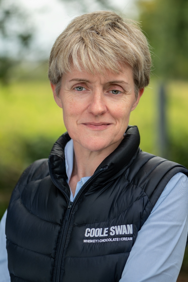 Fair-haired woman in blue jacket.