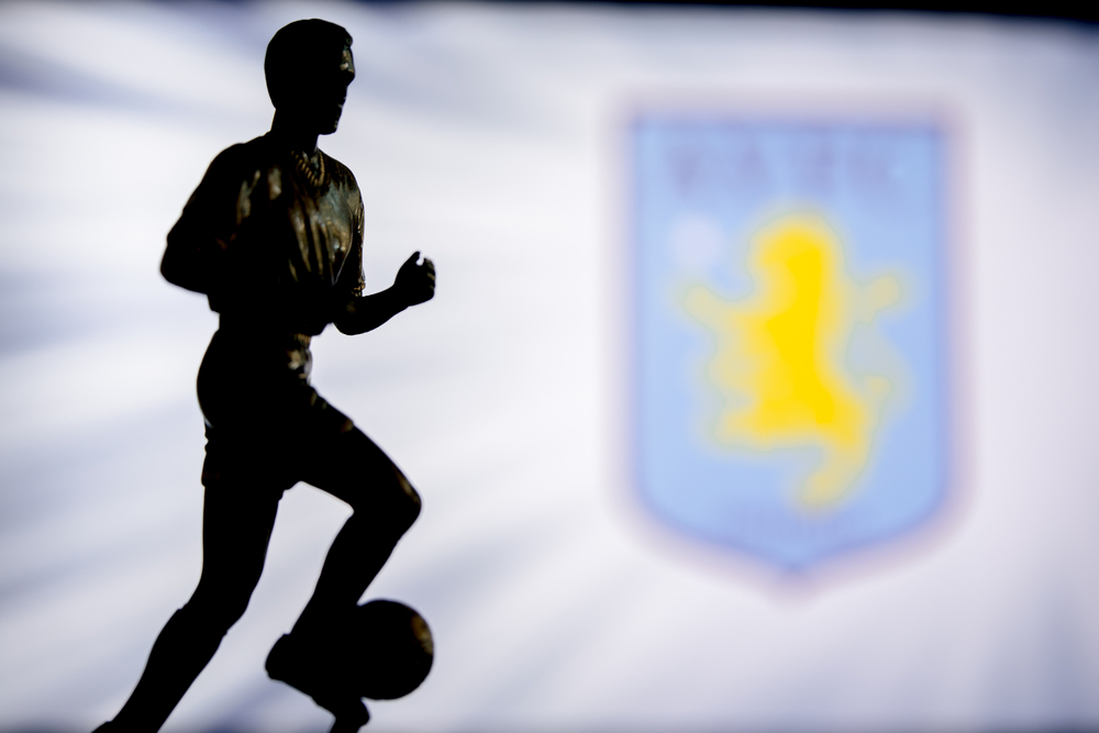 Footballer sculpture in front of Aston Villa crest.