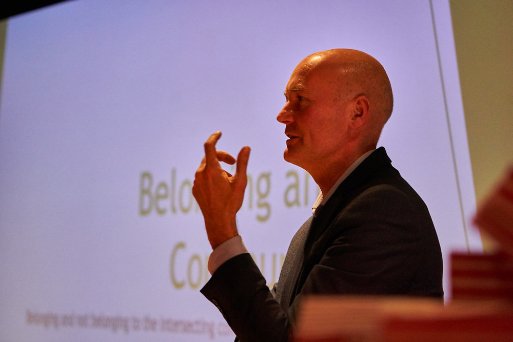 Man speaking on stage.