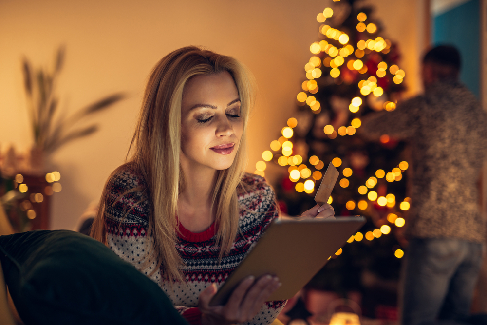 Woman shopping on a tablet computer at Christmas.