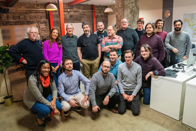 Group of people posing for photo.