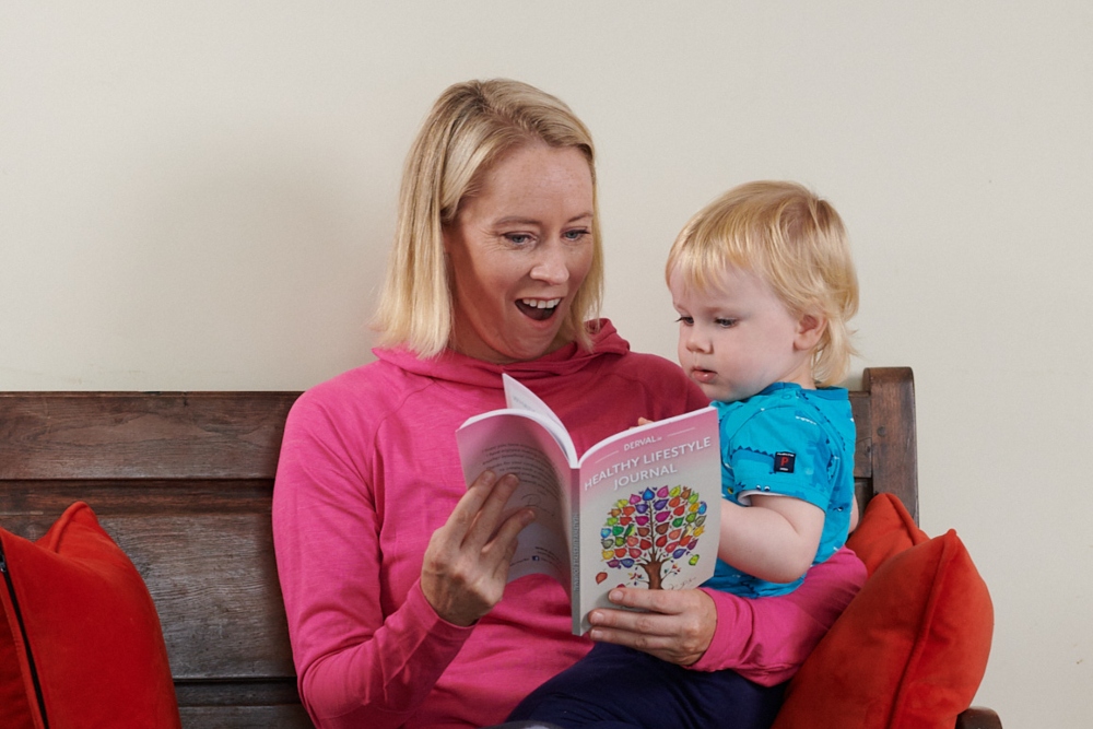 Woman and baby looking at a book.