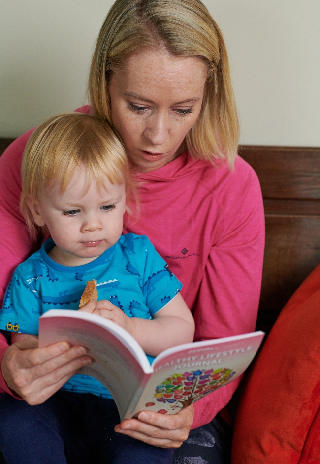 Woman and baby reading a book.