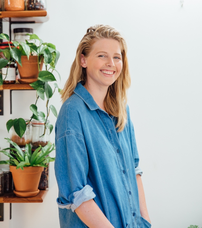 Blonde woman in blue denim shirt.