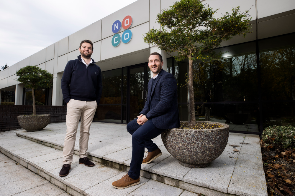 Two men outside offices.