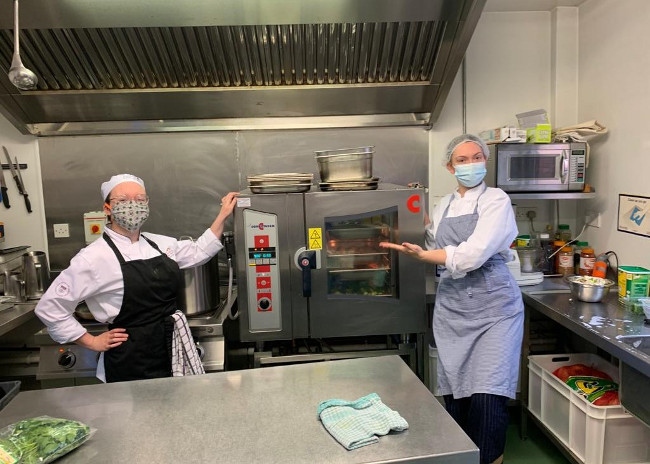 Women working in a community kitchen.