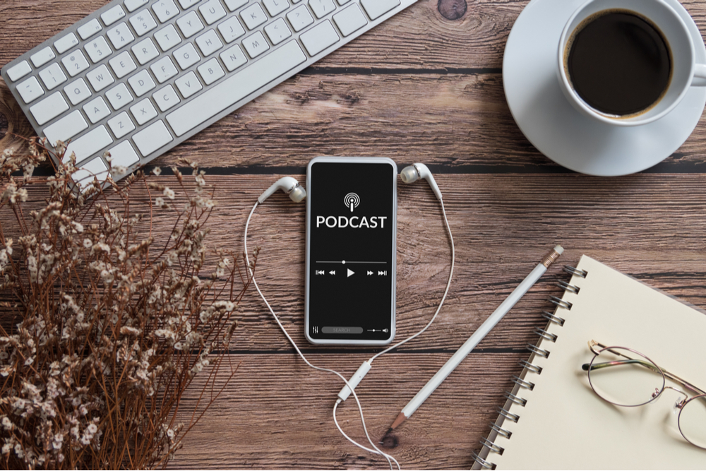 Smartphone on a business desk playing a podcast.