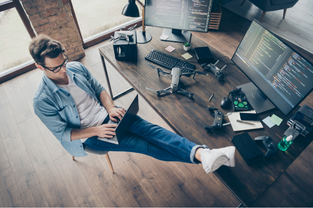 Man in blue shirt working from home.