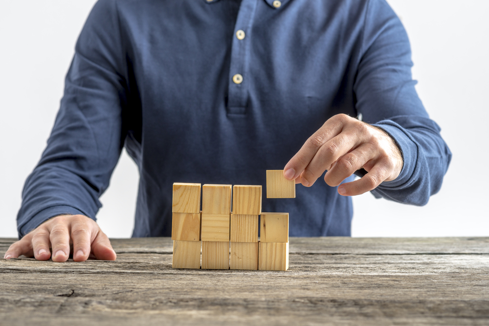 Man building with wooden blocks.