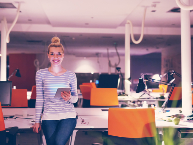 Woman in stripy shirt standing in office.