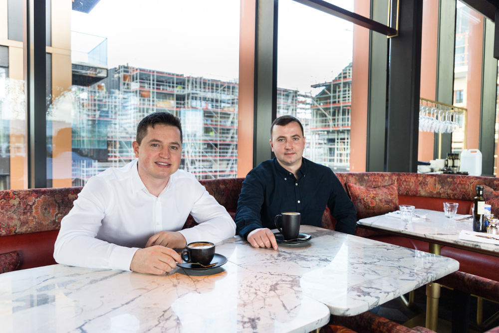 Two young men sitting at a table.