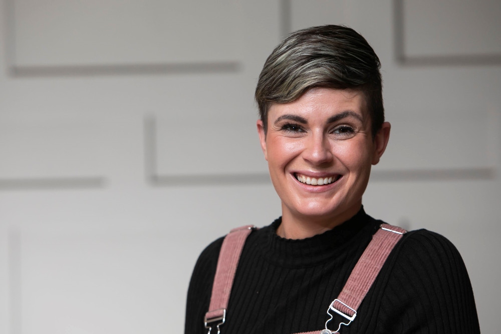 Smiling woman with short hair.