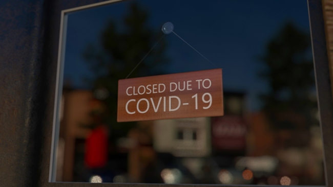 Closed sign in a window of a shop due to Covid.