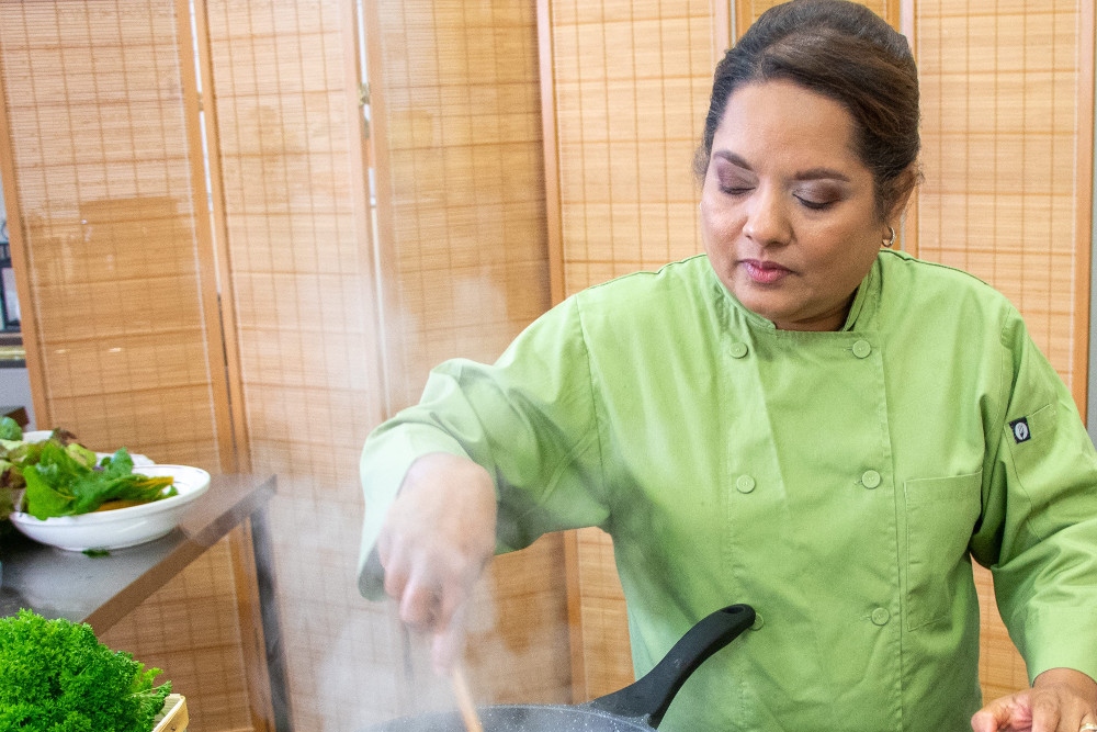 Woman chef cooking in kitchen.