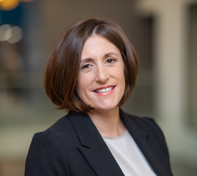 Dark -haired woman in business suit.