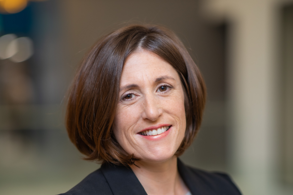 Dark-haired woman in business suit.