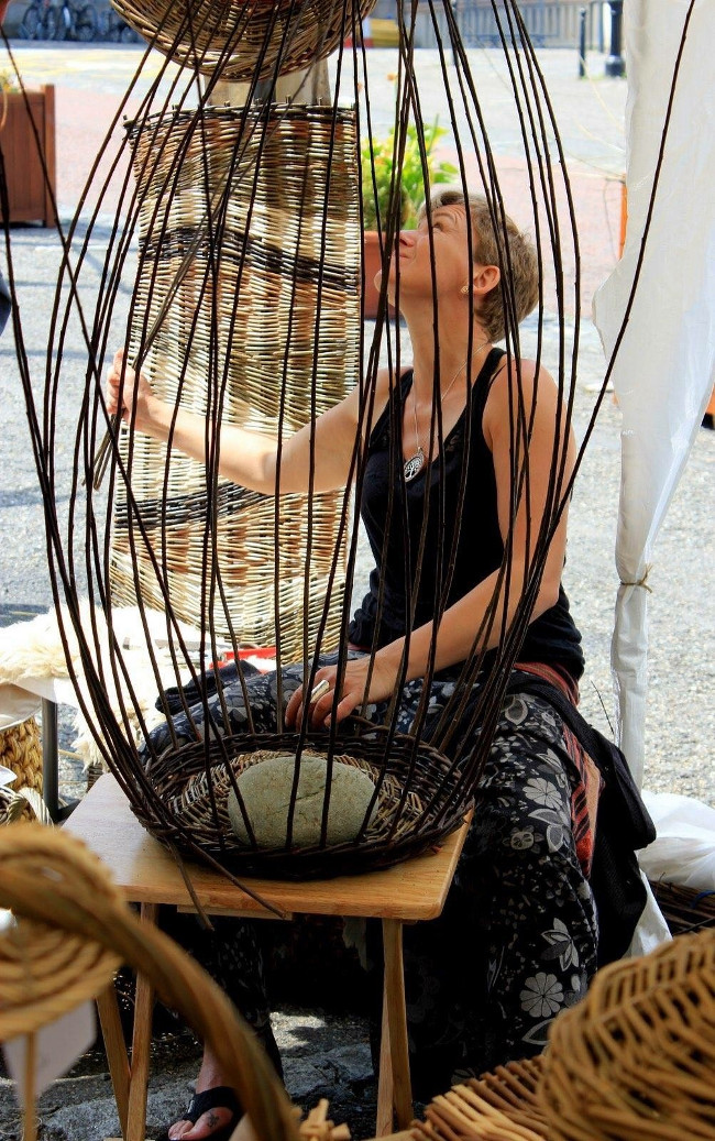 Woman weaving with willow rods.