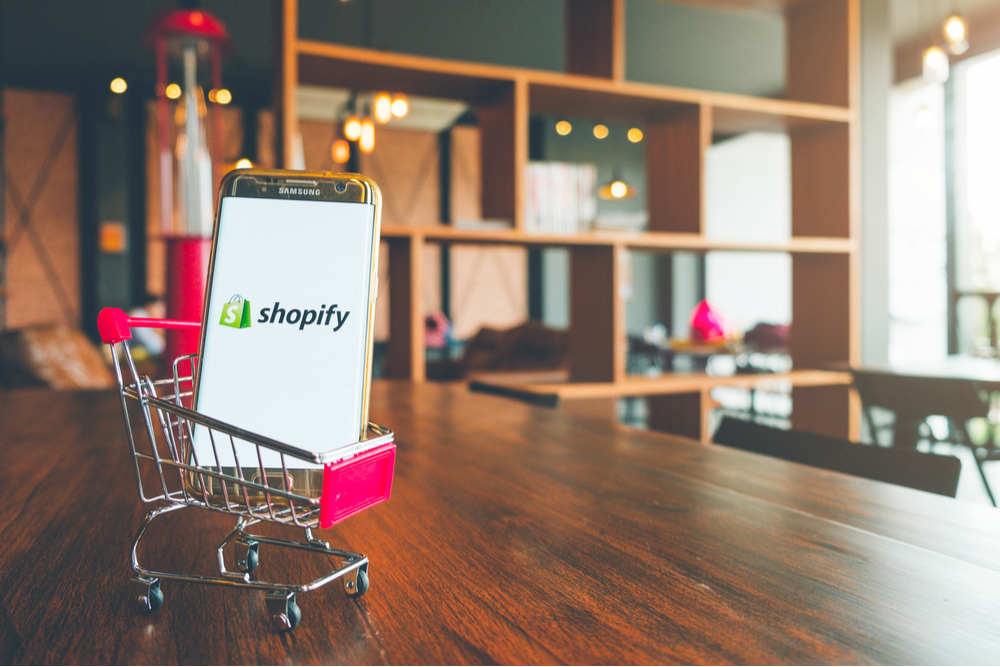 Smartphone with Shopify screen in a trolley in a store.