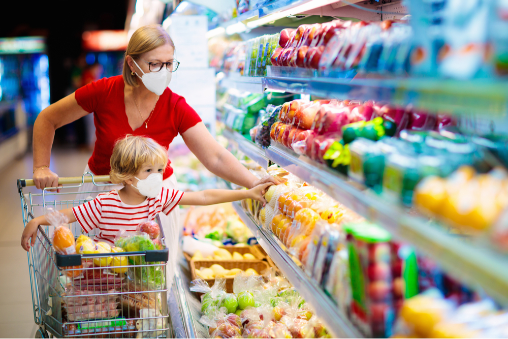 Woman and child shopping while wearing Covid masks.