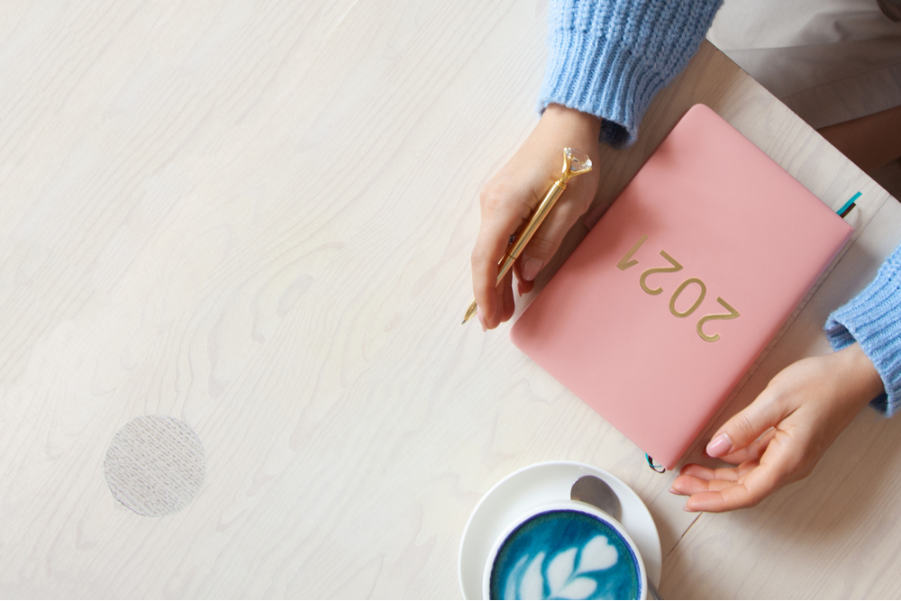 Woman holding 2021 diary.