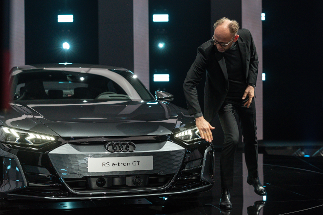 Man inspecting new Audi electric car.
