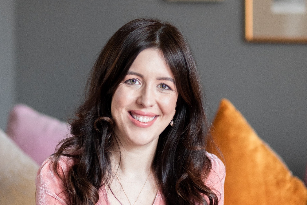 Dark-haired woman in pink dress.