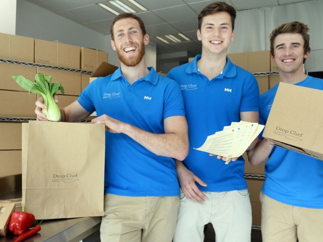 Three men in blue t-shirts.