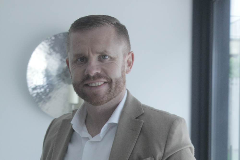 Bearded man in sports jacket.