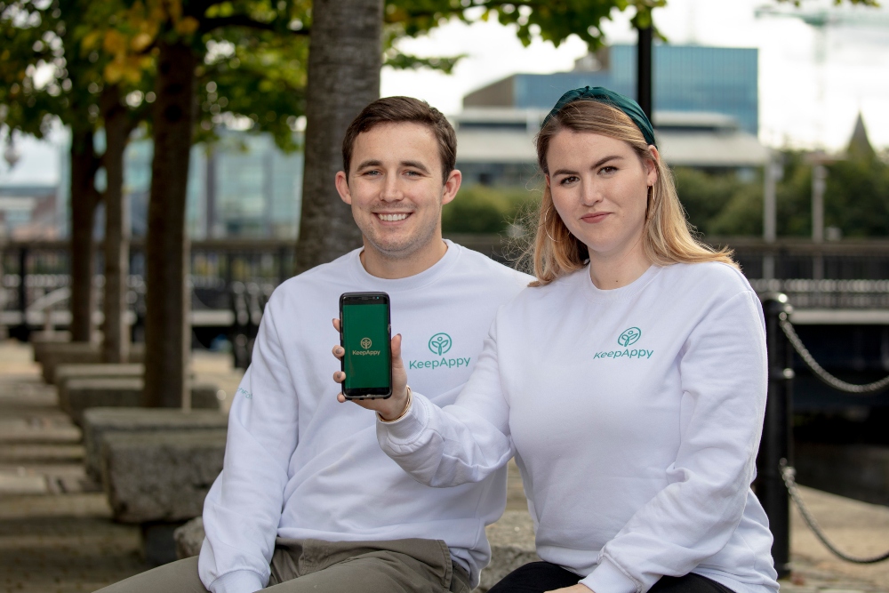 Young man and woman in white sweatshirts.