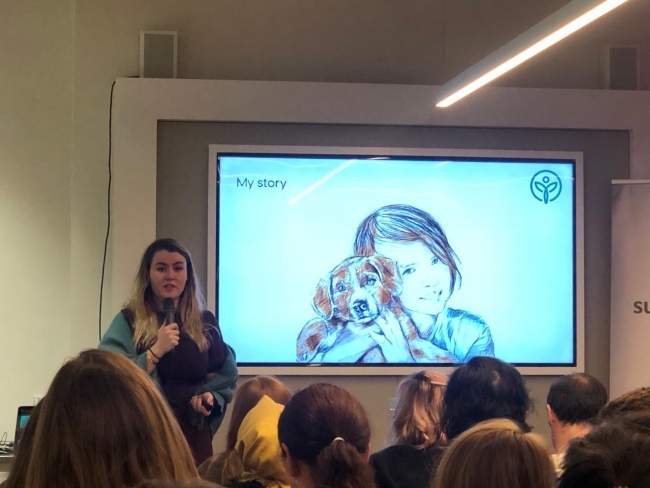 Young woman speaking with a microphone.