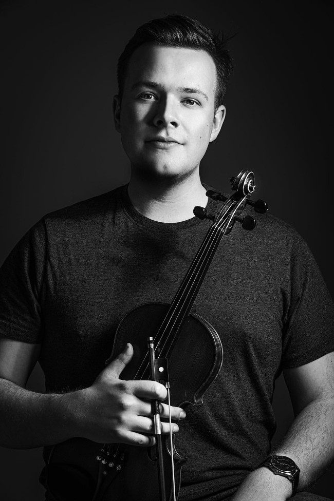 Young man holding a violin.