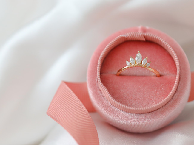 Diamond ring in a pink box.