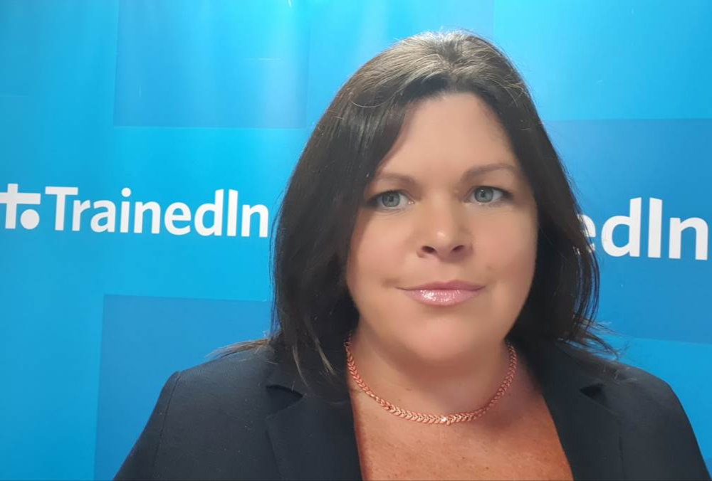 Dark-haired woman in business suit.