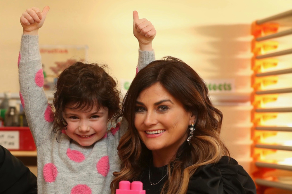 Woman and a child at a childcare facility.