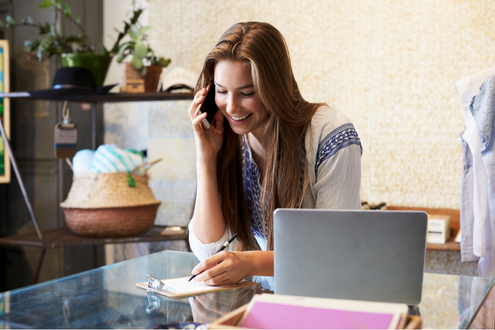 Woman business owner negotiating on a phone.