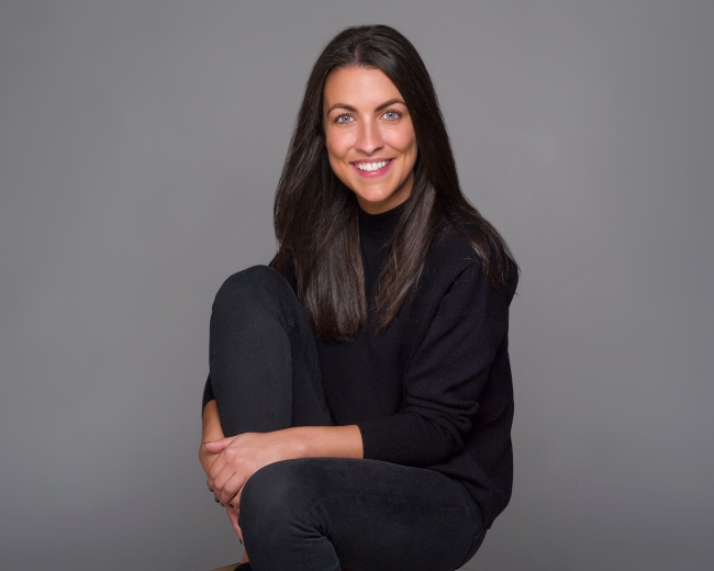 Smiling woman with dark hair.