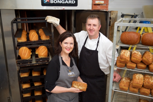 Man and woman working in a bakery.