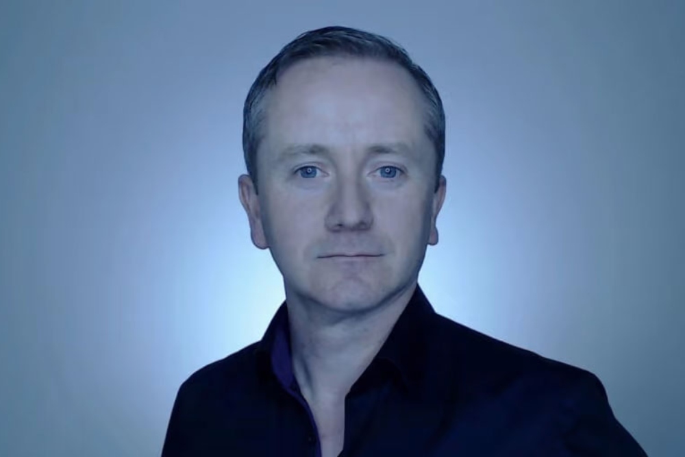 Man with short hair and black shirt.