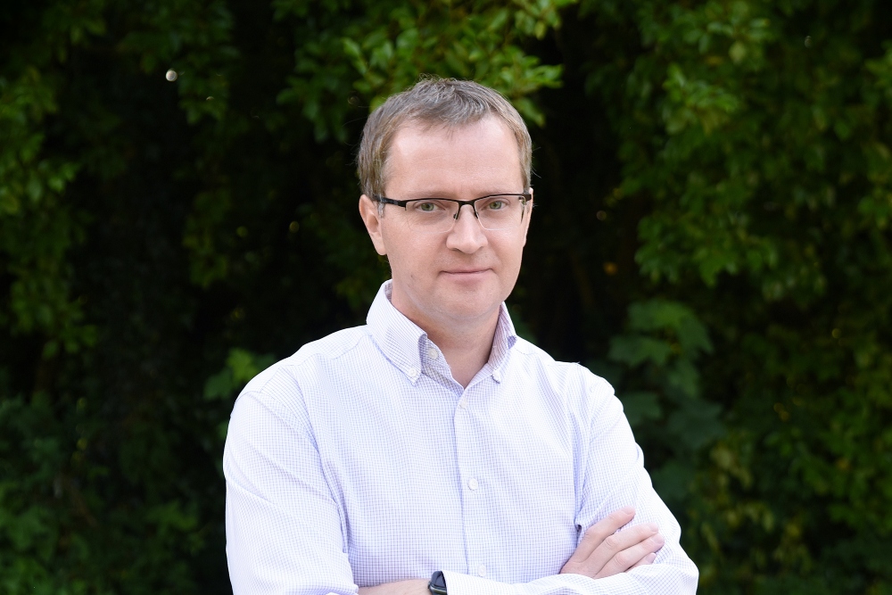 Man in white shirt and glasses.