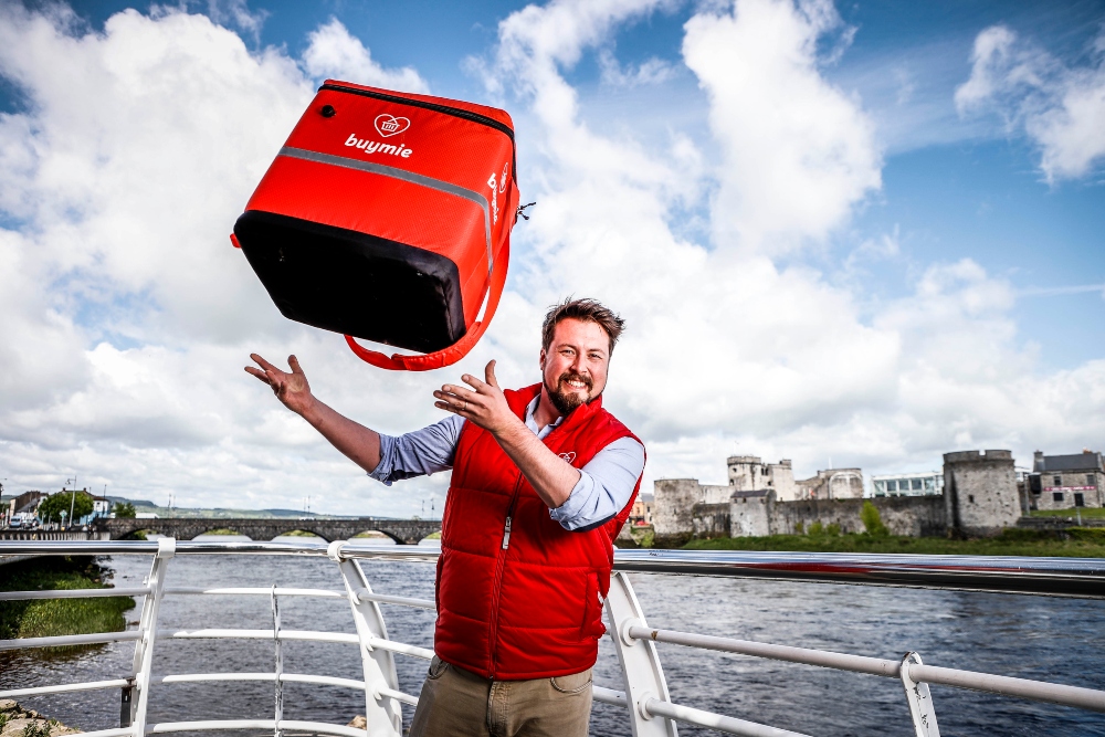 Man in red gillet jacket beside River Shannon, Limerick.