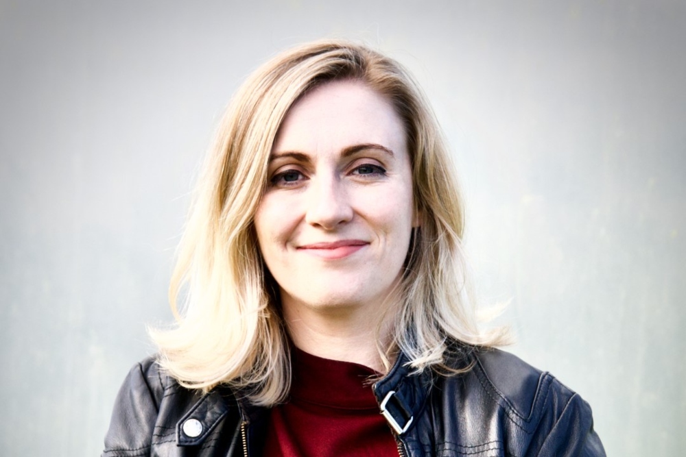 Blonde-haired woman in black leather jacket.