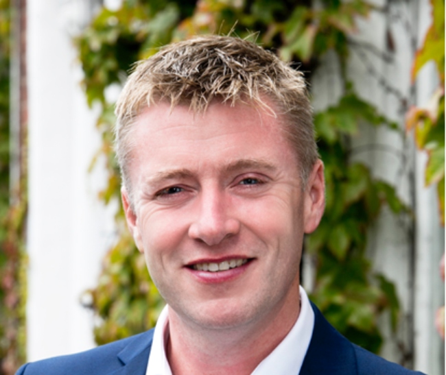 Fair-haired man in blue suit.